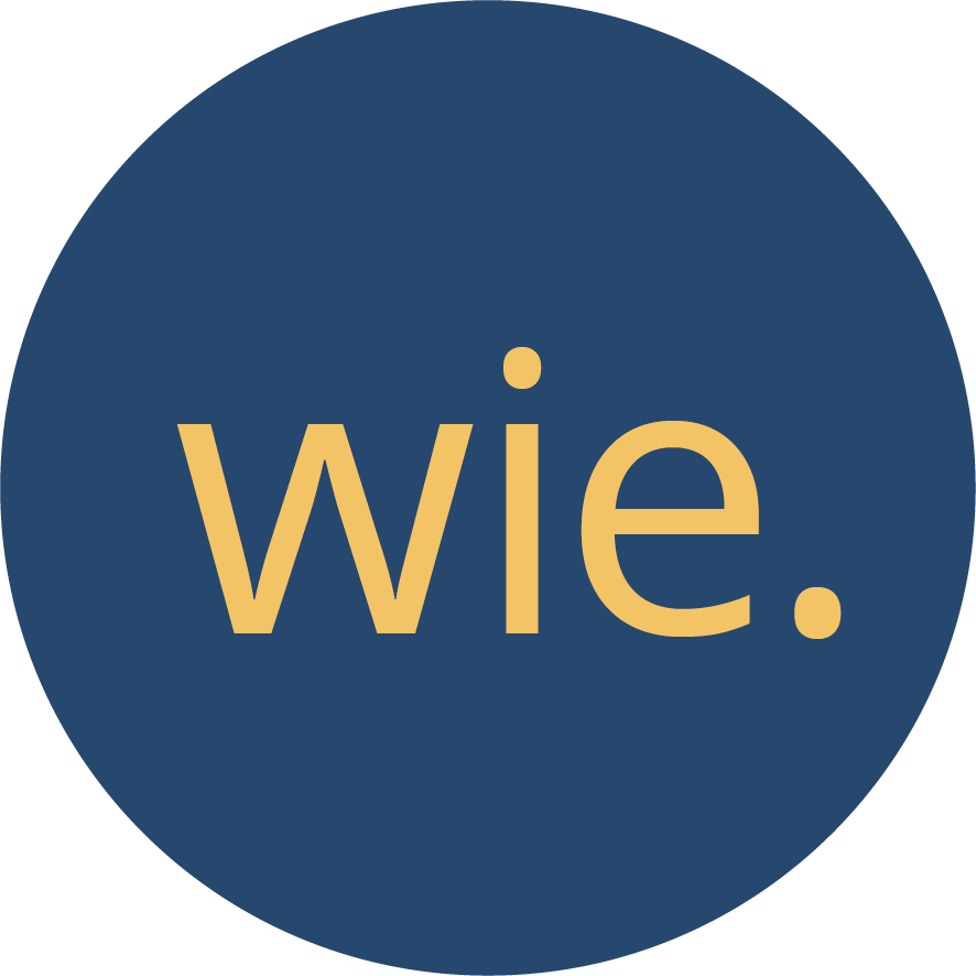 Ein weisser Kreis in dem das Wort "wie" steht, das Element dient zur Navigation auf der Webseite.